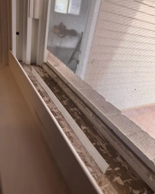 A window track before cleaning